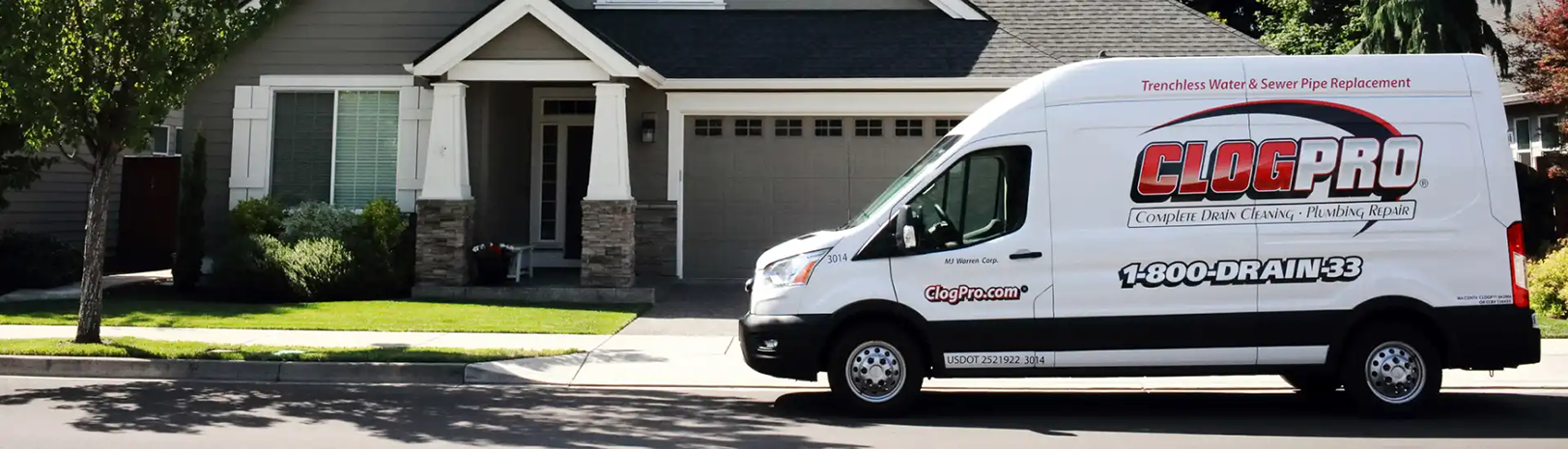 Clog Pro Truck sitting in front of a residential house. Trust Clog Pro Plumber for expert repairs. 