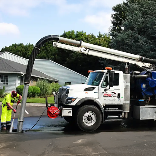 Clog Pro Truck Servicing a Pump Under a Residential House. Trust Clog Pro Plumber for expert repairs.