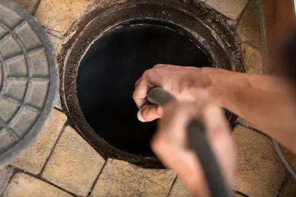 Plumber fixing bathroom sink.